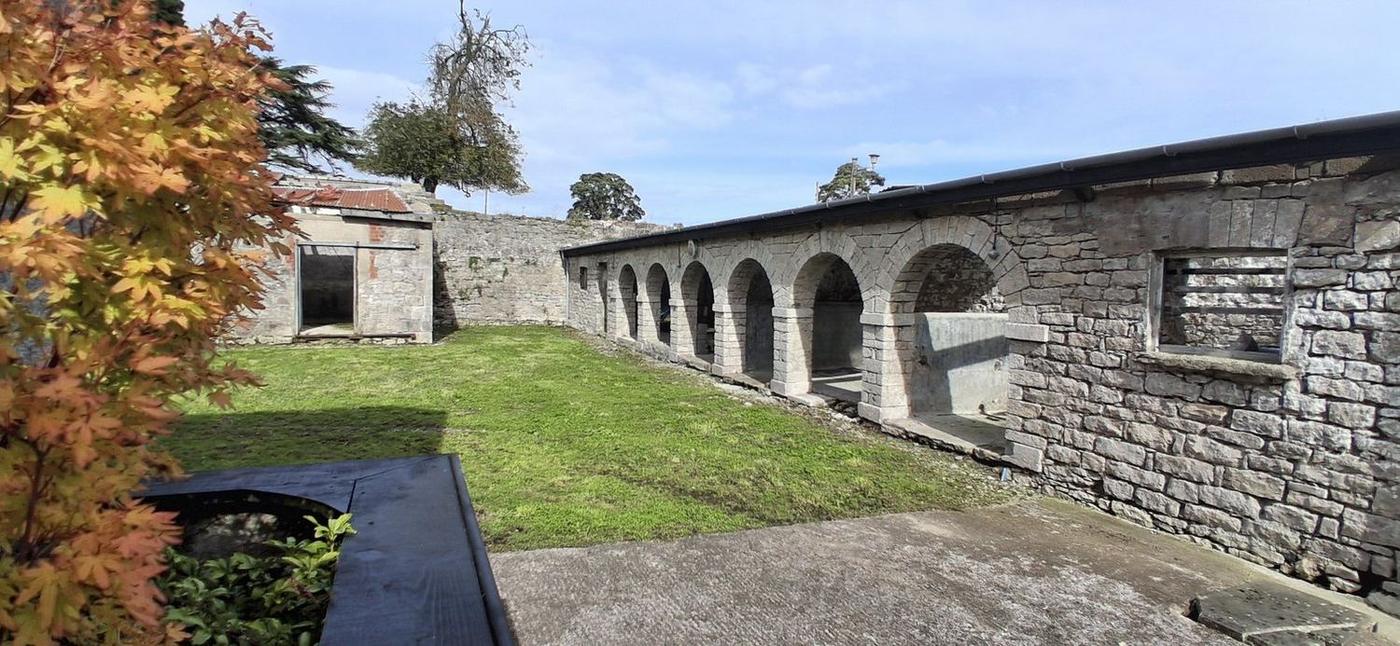 The arcaded range along one side of the courtyard