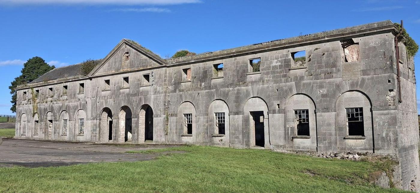 The front of the stable block: pediment, oculus and open arches