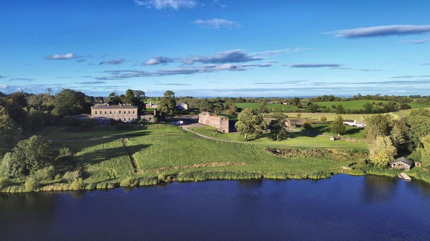 Aerial view of Castledillon Stables and Castle Dillon House above the lake