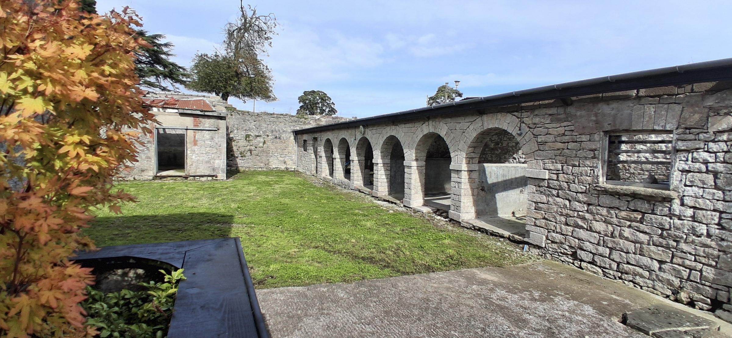 The arcaded range along one side of the rear courtyard